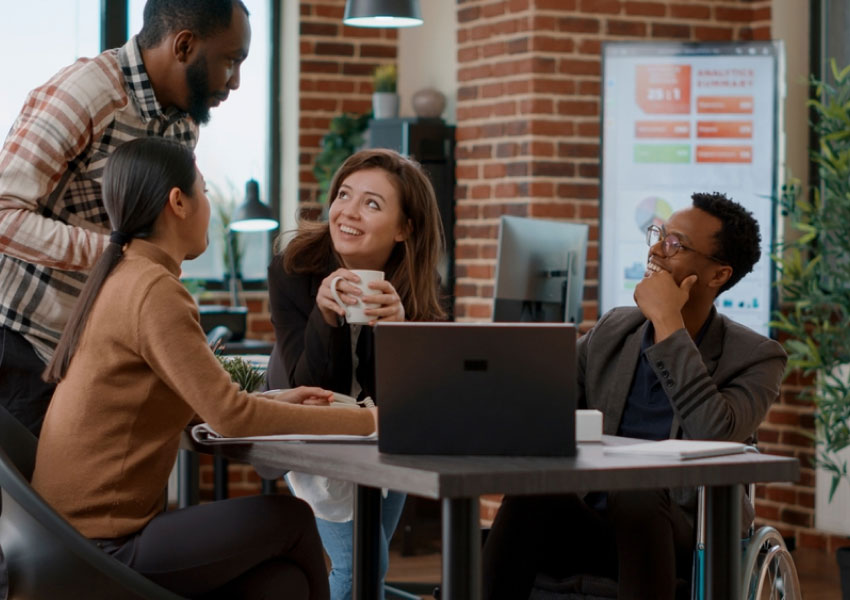 4 people having a conversation at work