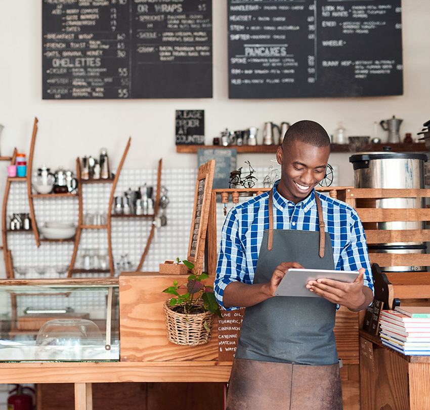 Proud owner of a small business using a tablet